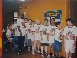 Conley posing with students